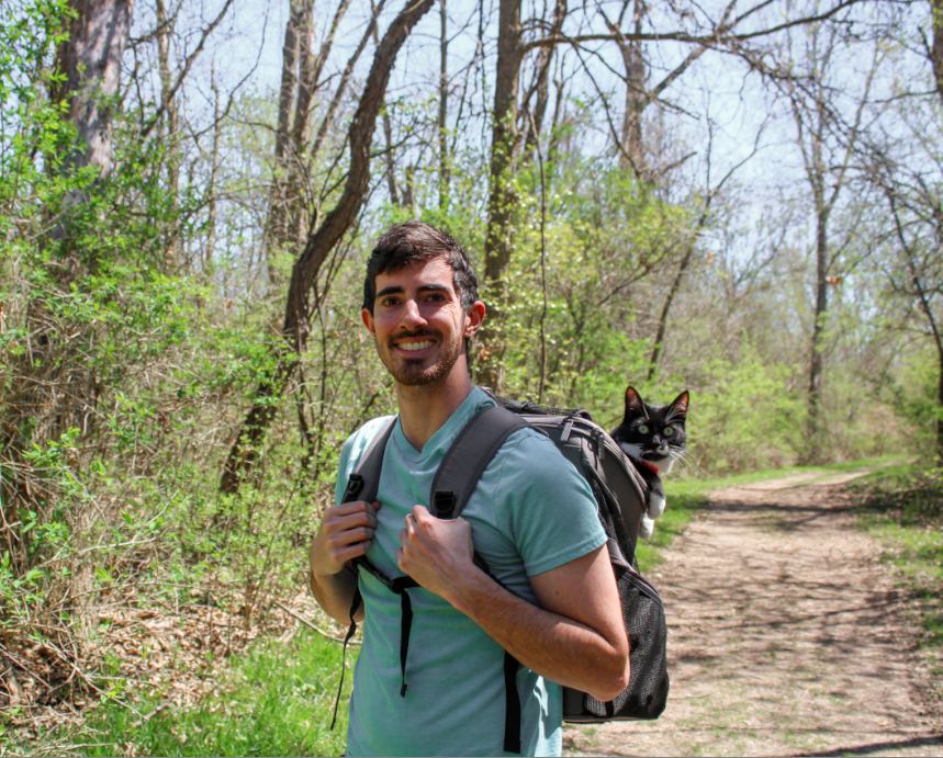 Picture of man with a cat on a trail